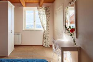 a living room with a table and a window at Country House Ca'Balsomino in Urbino