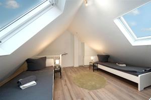 a attic room with a bed and a table at Work & Stay Apartment in Gelsenkirchen in Gelsenkirchen