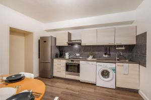 a kitchen with a washer and a sink and a dishwasher at Work & Stay Apartment in Gelsenkirchen in Gelsenkirchen