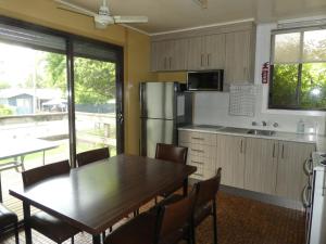 a kitchen with a wooden table and a refrigerator at Kiewa View in Mount Beauty