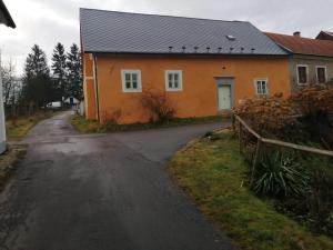 a small orange house with a road in front of it at Měšťanský dům Rožmberk 31 in Rožmberk nad Vltavou
