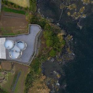 an aerial view of a building next to the water at Luxury Pool Villa, Villecot in Seogwipo