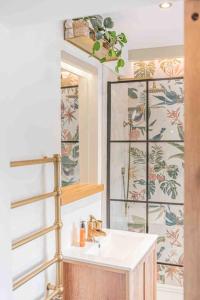 a bathroom with a sink and a mirror at Teapot Cottage in Ennerdale - Hot tub Pizza Oven Log Burner in Cleator