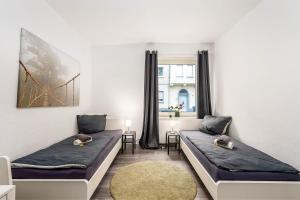 a room with two beds and a window at work & stay in Gelsenkirchen in Gelsenkirchen