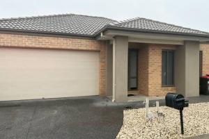 a house with a garage door in front of it at Comfort Heaven in Craigieburn