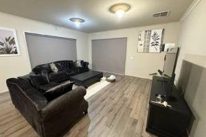 a living room with a couch and a television at Comfort Heaven in Craigieburn