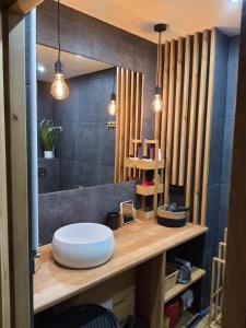 a bathroom with a counter with a sink and a mirror at Nadmorski Apartament in Gąski +25 photos