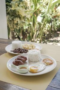 a plate of different types of donuts on a table at Diwa Siargao Eco-House in General Luna