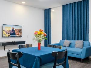 sala de estar con mesa azul y sofá en Paralia Hotel Nha Trang en Nha Trang