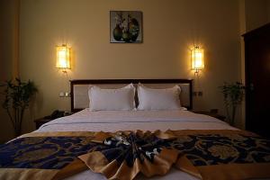 Letto o letti in una camera di Farah Hotel Apartment