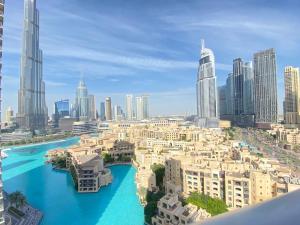 a view of a city with a river and buildings at Durrani Homes - The Residences 5BR Besides Dubai Mall with Burjkhalifa and Fountain view in Dubai +16 photos