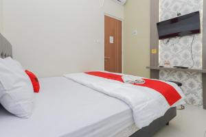 Un pat sau paturi într-o cameră la RedDoorz at Ngaggel Jaya Surabaya