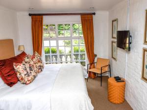 a bedroom with a white bed and a window at Backworth House in Mid Illovo