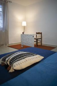 a pillow on a bed in a room at Mimosa House in Turin