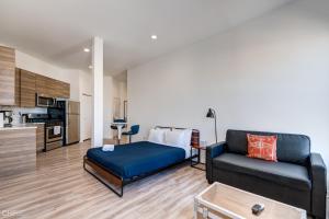 a living room with a couch and a kitchen at River West, Second Floor Chicago by 747 Lofts in Chicago