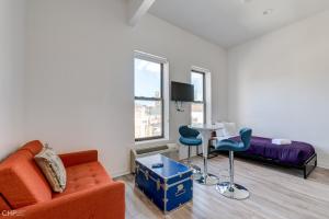 a living room with a couch and a table at 747 Lofts by RedAwning - River West, Second Floor Chicago in Chicago