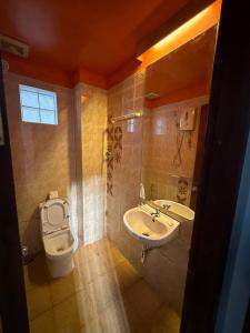 a bathroom with a sink and a toilet at Archaic House in Siem Reap