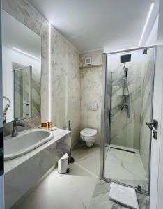 a bathroom with a shower and a sink and a toilet at Boutique Villa Isabelle in Predeal