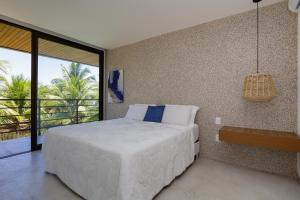 a bedroom with a large bed and a large window at Casa Maçunim 1 in Pôrto de Pedras +19 photos