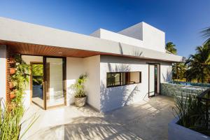 a white house with a patio and a swimming pool at Casa Maçunim 1 in Pôrto de Pedras
