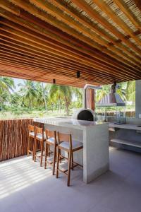 a kitchen with a table and chairs and a stove at Casa Maçunim 1 in Pôrto de Pedras