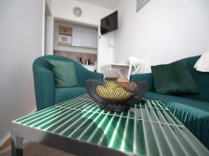 a bowl on a green table in a living room at Apartment Lea in Dubrovnik