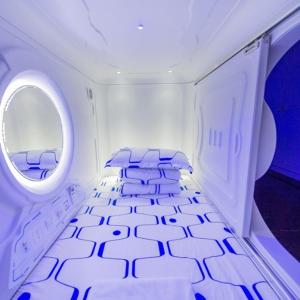 a room with an airplane with a circular window at Capsule Inn in Kota Kinabalu