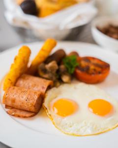 a plate of breakfast food with eggs and vegetables at Al Khoory Inn Bur Dubai in Dubai