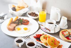 a table topped with plates of breakfast foods and drinks at Al Khoory Inn Bur Dubai in Dubai