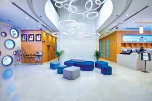 a lobby with blue seating in a store at Al Khoory Inn Bur Dubai in Dubai