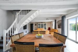 a dining room with a wooden table and chairs at Villa de 4 chambres avec piscine privee jardin amenage et wifi a Saint Sylvestre sur Lot in Saint-Sylvestre-sur-Lot