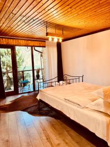 a bedroom with a large bed with a wooden ceiling at Nautica Bahna in Orşova +39 photos