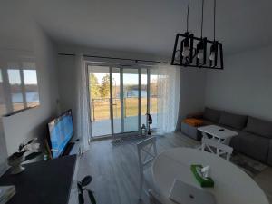 Televízia a/alebo spoločenská miestnosť v ubytovaní Apart Białe Augustów