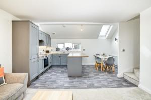 a kitchen and living room with a couch and a table at Number 4 on The Hill in Lincolnshire