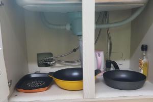 a kitchen counter with two pans and a sink at Lakeside Mirinae Villa in Anseong