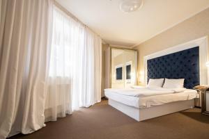 een slaapkamer met een bed en een groot raam bij Private Rooms in Hotel Lift 1R in Boekovel