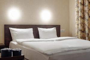 Postel nebo postele na pokoji v ubytování Private Rooms in Hotel GROFA 3 поверх
