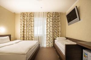 Postel nebo postele na pokoji v ubytování Private Rooms in Hotel GROFA 3 поверх