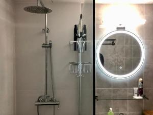 a shower with a glass door and a mirror at Casa Piedra Abajo in Pals +42 photos