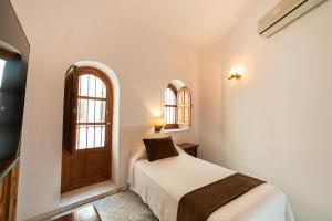 Posteľ alebo postele v izbe v ubytovaní Hotel Casa Palacio la Sal