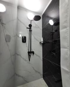 a bathroom with a shower with a shower head at К7 family in Atyraū