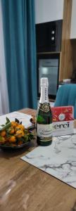 a bottle of beer sitting on a table with a plate of vegetables at К7 family in Atyrau