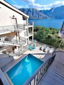 a swimming pool on a balcony with a view of the water at Blue Bay 2 bedroom apartment in Prčanj