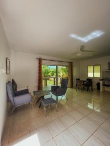 a living room with chairs and a table and a table at South Mountain Resort in Siquijor