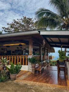 a porch of a house with a wooden deck at South Mountain Resort in Siquijor