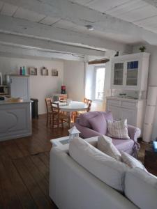 a living room with a couch and a table at Travers de Pechméjà in Lissac et Mouret
