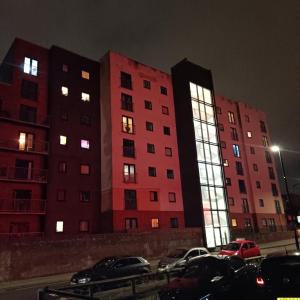 two tall buildings are lit up at night at Manchester City Quantum in Manchester
