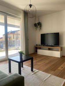 a living room with a flat screen tv and a table at Atmosphera home in Castel di Sangro +6 photos