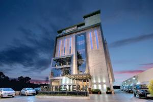 a building with cars parked in a parking lot at Best Western Summerlea jalandhar in Jalandhar