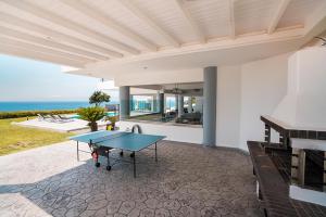 a ping pong table on the patio of a house at Monte Smith Luxury Villas in Rhodes Town